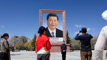 People take photo in front of a large portrait of Chinese President Xi Jinping, during a government-organized tour, at Potala Palace Square in Lhasa, Tibet Autonomous Region, China, March 28, 2025. REUTERS/Go Nakamura