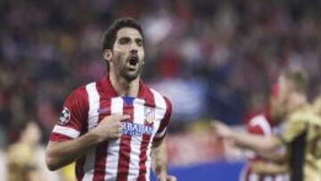 El centrocampista del Atlético de Madrid Raúl García celebra su gol, tercero del equipo, durante el partido de vuelta de los octavos de final de la Liga de Campeones que Atlético de Madrid y Milan