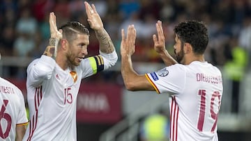 Spain's Diego Costa (R) celebrates with teammate Sergio Ramos after scoring a goal during the FIFA World Cup 2018 qualifying football match between Macedonia and Spain at Philip II of Macedon Stadium in Skopje on June 11, 2017. / AFP PHOTO / Robert A