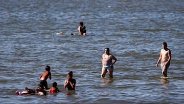 People bathe in the Rio de la Plata river during a heat wave amid the outbreak of the coronavirus disease (COVID-19), in Buenos Aires, Argentina January 25, 2021. REUTERS/Agustin Marcarian