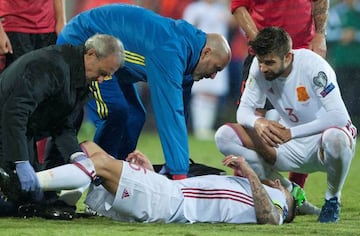 Ramos is treated by Spain's medical staff after suffering his knee injury.