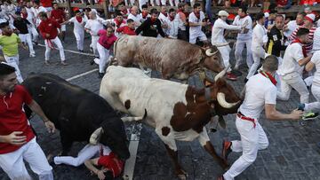 PAMPLONA, SPAIN - JULY 08: People take part in the traditional Running of the bulls during the San Fermin Festival in Pamplona, Navarra, Spain, 08 July 2022. Pamplona's Running of the Bulls, known locally as Sanfermines, resumed after a two-year hiatus due to the COVID-19 pandemic. The bull-running fiesta is held annually from 06 to 14 July in commemoration of the city's patron saint. Visitors from all over the world attend the festival. Many of them physically participate in the highlight event - the running of the bulls, or encierro - where they attempt to outrun the animals along a route through the narrow streets of Pamplona's old city. (Photo by Burak Akbulut/Anadolu Agency via Getty Images)