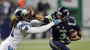 Seattle Seahawks quarterback Russell Wilson (3) pushes off of Carolina Panthers&#039; Ryan Delaire as he runs with the ball in the first half of an NFL football game, Sunday, Dec. 4, 2016, in Seattle. (AP Photo/Stephen Brashear)