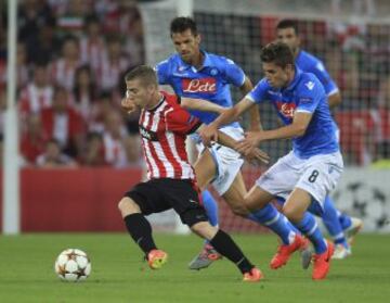 El delantero del Athletic Club Iker Muniain (i) se escapa del centrocampista brasileño Jorginho Frello (d), del Nápoles, durante el partido de vuelta de la fase previa de la Liga de Campeones que se disputa esta tarde en el estadio de San Mamés, en Bilbao. 