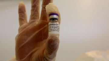 BARI, ITALY - APRIL 28: A nurse holds a vial of the Comirnaty Pfizer vaccine on April 28, 2021 in Bari, Italy. After being slowed down because of suppliers being late with the vaccine shipping, the recently updated COVID-19 vaccination plan sees 62 millio