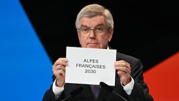International Olympic Committe (IOC) President Thomas Bach announces that the French Alps have won the bid for the 2030 Winter Games during the 142nd session of the International Olympic Committee (IOC) in Paris on July 24, 2024, ahead of the Paris 2024 Olympic Games. (Photo by Fabrice COFFRINI / AFP)