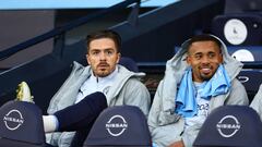 MANCHESTER, ENGLAND - APRIL 20: Jack Grealish and Gabriel Jesus of Manchester City look on from the bench during the Premier League match between Manchester City and Brighton & Hove Albion at Etihad Stadium on April 20, 2022 in Manchester, England. (Photo by Clive Brunskill/Getty Images)