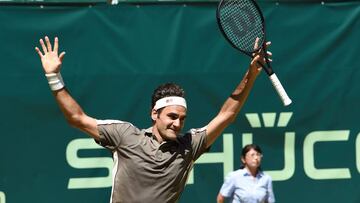 Roger Federer from Switzerland reacts after he won his final match against David Goffin from Belgium at the ATP tennis tournament in Halle, western Germany, on June 23, 2019. (Photo by Carmen JASPERSEN / AFP)