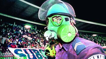 Serb policeman wears a gas-mask after a teargas grenade was thrown during Group Eight, Euro 2000 qualifier soccer match Croatia vs Yugoslavia, Wednesday August 18, 1999, in Belgrade, Yugoslavia. The match was delayed for 40 minutes, and ended with a 0-0 r