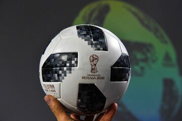A participant holds the official match ball for the 2018 World Cup, named "Telstar 18", during its unveiling ceremony in Moscow on November 9, 2017