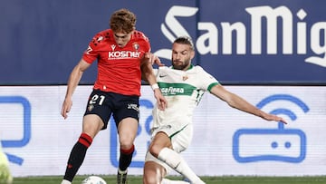MADRID, 25/09/2025.- El delantero del Osasuna Víctor Muñoz (izda) pelea por el balón con el defensa francés del Elche, Leo Petrot, durante el partido de la jornada 6 de Liga que disputan este jueves ante el Osasuna en el estadio El Sadar en Pamplona. EFE/Jesús Diges