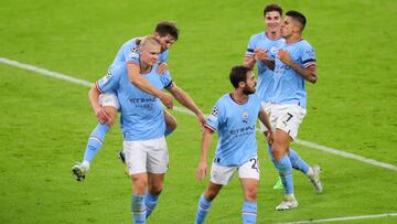 MANCHESTER, ENGLAND - SEPTEMBER 14: Erling Haaland of Manchester City celebrates with team mates John Stones and Bernardo Silva after scoring their sides second goal during the UEFA Champions League group G match between Manchester City and Borussia Dortmund at Etihad Stadium on September 14, 2022 in Manchester, England. (Photo by Alex Livesey - UEFA/UEFA via Getty Images)