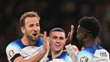 England's striker #09 Harry Kane (L) celebrates with teammates after scoring his team second goal during the UEFA Euro 2024 Group C qualifying football match between England and Malta, at Wembley stadium, in north London, on November 17, 2023. (Photo by Glyn KIRK / AFP) / NOT FOR MARKETING OR ADVERTISING USE / RESTRICTED TO EDITORIAL USE