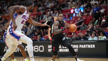 Apr 4, 2024; Miami, Florida, USA;  Miami Heat guard Terry Rozier (2) drives to the basket as Philadelphia 76ers center Joel Embiid (21) defends during the first half at Kaseya Center. Mandatory Credit: Jim Rassol-USA TODAY Sports