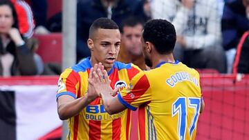 Valencia's Spanish forward Rodrigo Moreno (L) celebrates with Valencia's French midfielder Francis Coquelin after scoring a goal during the Spanish league football match between Sevilla and Valencia at the Ramon Sanchez Pizjuan stadium in Sevill