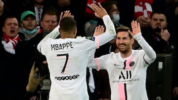 Lionel Messi is congratulated by Kylian Mbappe after scoring against Lille. 