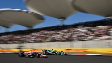 Aston Martin's Spanish driver Fernando Alonso (R) and Red Bull Racing's French driver Isack Hadjar (L) drive during the qualifying session ahead of the Formula One Chinese Grand Prix at the Shanghai International Circuit in Shanghai on March 14, 2026. (Photo by Hector RETAMAL / AFP)