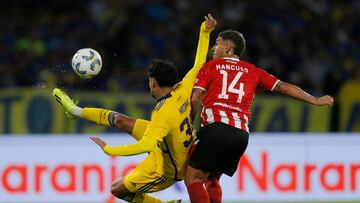 Boca Juniors' midfielder Cristian Medina (L) kicks the ball past Estudiantes's defender Eros Mancuso during the Argentine Professional Football League Cup semifinal match between Estudiantes de La Plata and Boca Juniors at the Mario Alberto Kempes Stadium in Cordoba, Argentina, on April 30, 2024. (Photo by Diego Lima / AFP)