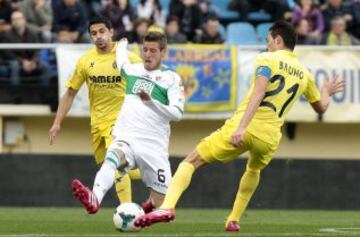 El centrocampista del Villarreal Bruno Soriano lucha un balón con el centrocampista del Elche Rubén Pérez, durante el partido de la trigésima primera jornada de liga de Primera División disputado esta tarde en el estadio de El Madrigal.