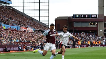 Aston Villa's English midfielder #27 Morgan Rogers (L) crosses the ball under pressure from Fulham's English-born US defender #33 Antonee Robinson (R) during the English Premier League football match between Aston Villa and Fulham at Villa Park in Birmingham, central England on May 3, 2025. (Photo by Adrian Dennis / AFP) / RESTRICTED TO EDITORIAL USE. No use with unauthorized audio, video, data, fixture lists, club/league logos or 'live' services. Online in-match use limited to 120 images. An additional 40 images may be used in extra time. No video emulation. Social media in-match use limited to 120 images. An additional 40 images may be used in extra time. No use in betting publications, games or single club/league/player publications. /