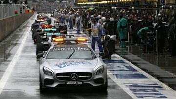 The safety car remains in front of the cars during a halt during the Brazilian Grand Prix at the Interlagos circuit in Sao Paulo, Brazil, on November 13, 2016. / AFP PHOTO / POOL / PAULO WHITAKER