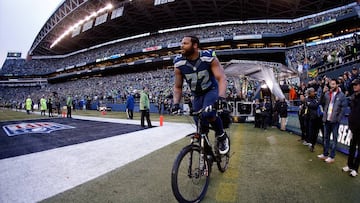 SEATTLE, WA - JANUARY 18: Michael Bennett #72 of the Seattle Seahawks rides a police bike after the Seahawks 28-22 overtime victory against the Green Bay Packers during the 2015 NFC Championship game at CenturyLink Field on January 18, 2015 in Seattle, Washington. (Photo by Otto Greule Jr/Getty Images)