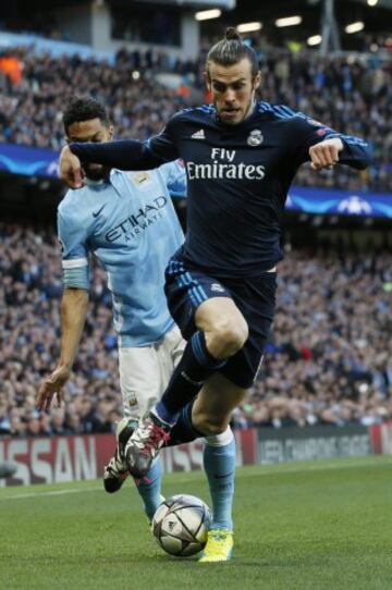 Gael Clichy and Gareth Bale vie for a ball.