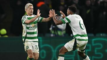 Celtic's Japanese striker #38 Daizen Maeda (L) celebrates after scoring the equalising goal with Celtic's US defender #06 Auston Trusty during the UEFA Champions League football match between Celtic and Club Brugge at Celtic Park stadium in Glasgow, Scotland on November 27, 2024. (Photo by Paul ELLIS / AFP)