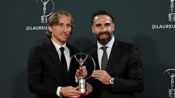 Real Madrid's Spanish defender Dani Carvajal and Real Madrid's Croatian midfielder Luka Modric hold the 26th Laureus World Sports Awards Team Trophy during the gala in Madrid on April 21, 2025. (Photo by JAVIER SORIANO / AFP)