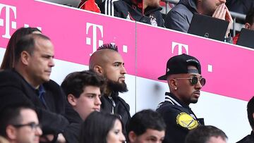 MUNICH, GERMANY - APRIL 14: Arturo Vidal of Bayern Muenchen (l) and Jerome Boateng of Bayern Muenchen (r) are seen in the stands during the Bundesliga match between FC Bayern Muenchen and Borussia Moenchengladbach at Allianz Arena on April 14, 2018 in Mun