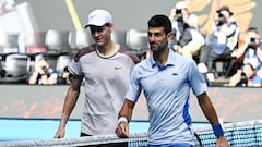 Italy's Jannik Sinner greets Serbia's Novak Djokovic (R) after victory in their men's singles semi-final match on day 13 of the Australian Open tennis tournament in Melbourne on January 26, 2024. (Photo by Paul Crock / AFP) / -- IMAGE RESTRICTED TO EDITORIAL USE - STRICTLY NO COMMERCIAL USE --