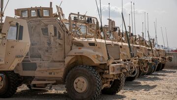 US Army soldiers from the 10th Mountain Division and U.S. contractors prepare Mine Resistant Ambush Protected vehicles, MRAPs, to be transported off of base in support of the withdrawal mission in Kandahar, Afghanistan.