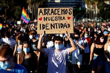 Un joven lleva una pancarta con el lema "Abracemos nuestra identidad" durante la manifestación del Orgull LGTB+.