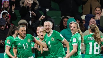 Ireland's midfielder #11 Katie McCabe (2nd L) celebrates with her teammates after scoring her team's first goal during the Australia and New Zealand 2023 Women's World Cup Group B football match between Canada and Ireland at Perth Rectangular Stadium in Perth on July 26, 2023. (Photo by Colin MURTY / AFP)