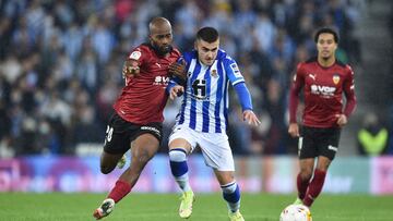 SAN SEBASTIAN, SPAIN - NOVEMBER 21: Dimitri Foulquier of Valencia CF battles for possession with Ander Barrenetxea of Real Sociedad during the La Liga Santander match between Real Sociedad and Valencia CF at Reale Arena on November 21, 2021 in San Sebasti