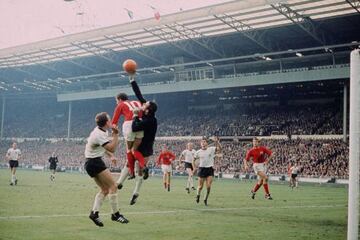 Geoff Hurst jumps with Hans Tilkowski.