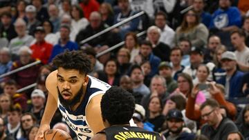 Mar 22, 2023; Minneapolis, Minnesota, USA; Minnesota Timberwolves forward Karl-Anthony Towns (32) controls the ball as Atlanta Hawks center Onyeka Okongwu (17) defends in the third quarter at Target Center. Mandatory Credit: Nick Wosika-USA TODAY Sports