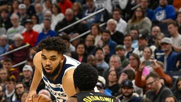 Mar 22, 2023; Minneapolis, Minnesota, USA;  Minnesota Timberwolves forward Karl-Anthony Towns (32) controls the ball as Atlanta Hawks center Onyeka Okongwu (17) defends in the third quarter at Target Center. Mandatory Credit: Nick Wosika-USA TODAY Sports