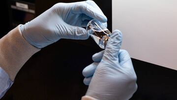 A lab technician visually inspects a filled vial of investigational coronavirus disease (COVID-19) treatment drug remdesivir at a Gilead Sciences facility in La Verne, California, U.S. March 11, 2020. Picture taken March 11, 2020. Gilead Sciences Inc/Hand