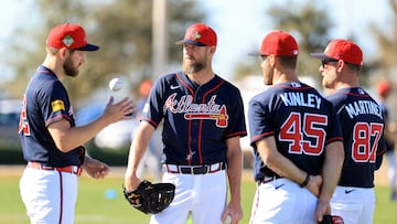 Feb 10, 2026; North Port, FL, USA; Atlanta Braves pitcher Chris Sale (51) talks with pitcher Dylan Lee (52), pitcher Tyler Kinley (45) and coach J.P. Martinez (87) works out during spring training workouts. Mandatory Credit: Kim Klement Neitzel-Imagn Images