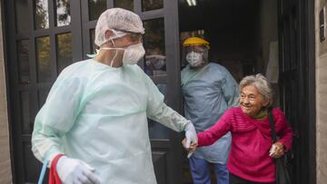 Medical staff evacuate an elderly woman from a nursing home after multiple residents of the facility tested positive for the COVID-19 coronavirus, in Buenos Aires, Argentina, Wednesday, April 22, 2020. (AP Photo/Natacha Pisarenko)
