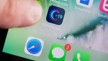 A man uses a Swedish version of the Covid Symptom Tracker app on his smartphone in Stockholm, Sweden, on April 29, 2020. - Sweden's Lund University developed the app to provide information about the spread of the novel coronavirus Covid-19 in Sweden. (Photo by Fredrik SANDBERG / TT News Agency / AFP) / Sweden OUT