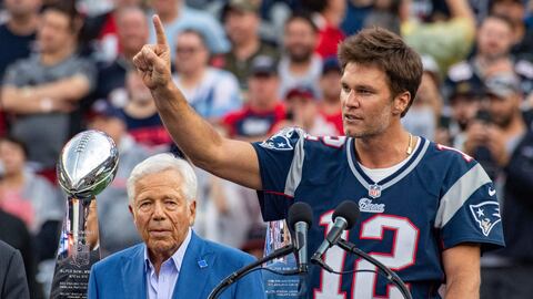 Former New England Patriots quarterback Tom Brady (R) gestures, flanked by CEO of the New England Patriots Robert Kraft, as he speaks to fans as he is honored during halftime of the season-opening game between the Patriots and the Philadelphia Eagles at Gillette Stadium in Foxborough, Massachusetts, on September 10, 2023. Tom Brady played for 20 seasons with the New England Patriots. (Photo by Joseph Prezioso / AFP)