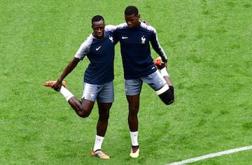 France's defender Benjamin Mendy (L) and France's midfielder Paul Pogba (R) take part in a training session of France's national football team at the Saint Petersburg Stadium, in Saint Petersburg, on July 9, 2018, on the eve of their Russia 2018 World Cup