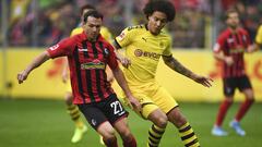 Freiburg&#039;s Nicolas Hoefler, left, and Dortmund&#039;s Axel Witsel, right, challenge for the ball during the German Bundesliga soccer match between SC Freiburg and Borussia Dortmund in Freiburg, Germany, Saturday, Oct. 5, 2019. (Patrick Seeger/dpa via