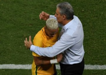 Brazil's Neymar (L) is embraced by Brazilian coach Tite during their Russia 2018 World Cup qualifier football match in Natal, Brazil, on October 6, 2016. / AFP PHOTO / VANDERLEI ALMEIDA