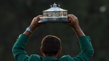 Scottie Scheffler of the U.S. celebrates with his green jacket and the trophy after winning The Masters.