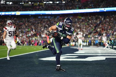 El número 88 de Seattle Seahawks, AJ Barner, atrapa el balón lanzado por su QB, Sam Darnold.