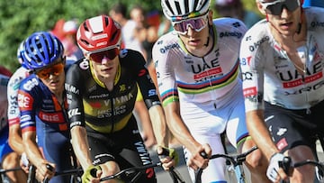 (FILES) Team Visma - Lease a bike team's Danish rider Jonas Vingegaard (center L) and UAE Team Emirates - XRG team's Slovenian rider Tadej Pogacar (center R) cycle in the ascent of Col des Borderes during the 12th stage of the 112th edition of the Tour de France cycling race, 180.6 km between Auch and Hautacam, in the Pyrenees mountains of southwestern France, on July 17, 2025. (Photo by Loic VENANCE / AFP)