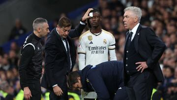 A medical staff's member tends to Real Madrid's French midfielder #12 Eduardo Camavinga during the Spanish league football match between Real Madrid CF and Rayo Vallecano de Madrid at the Santiago Bernabeu stadium in Madrid on November 5, 2023. (Photo by Pierre-Philippe MARCOU / AFP)